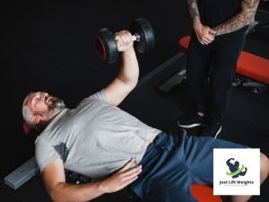 guying doing one arm dumbbell chest presses