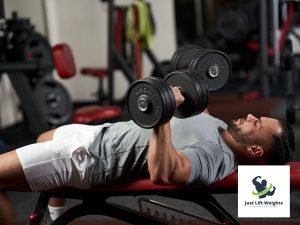 guy pushing dumbbells